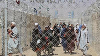 Afghan people walk inside a fenced corridor as they enter Pakistan at the Pakistan-Afghanistan border crossing point in Chaman on August 25, 2021 following the Taliban's stunning military takeover of Afghanistan. (AFP) Afghan people walk inside a fenced corridor as they enter Pakistan at the Pakistan-Afghanistan border crossing point in Chaman on August 25, 2021 following the Taliban's stunning military takeover of Afghanistan. (AFP)