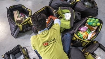 A delivery rider checks orders at a BigBasket warehouse in Noida, Uttar Pradesh. (Bloomberg)