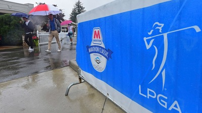 Fans walk near the clubhouse as play is suspended during the final round of the Marathon LPGA Classic golf tournament at Highland Meadows Golf Club in Sylvania, Ohio, Sunday, July 11, 2021, in Sylvania, Ohio. (AP Photo/David Dermer) (AP)