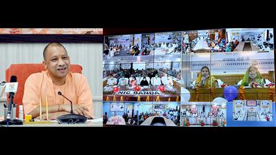 Uttar Pradesh CM Yogi Adityanath interacts with beneficiaries of Ujjwala 2,0 scheme, via video conferencing during a function at his official residence, in Lucknow on Wednesday. (ANI Photo)
