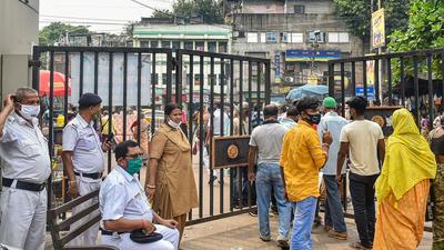 Police personnel deployed at the emergency gate of NRS Hospital where three teachers are admitted. The teachers attempted suicide on Tuesday, in Kolkata. (PTI PHOTO.) Police personnel deployed at the emergency gate of NRS Hospital where three teachers are admitted. The teachers attempted suicide on Tuesday, in Kolkata. (PTI PHOTO.)