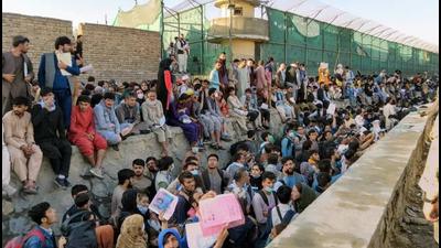 Crowds of people wait outside the airport in Kabul, Afghanistan, on Wednesday. (REUTERS) Crowds of people wait outside the airport in Kabul, Afghanistan, on Wednesday. (REUTERS)