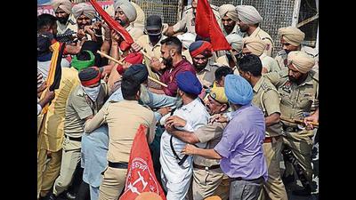 Farmers trying to get past police cordon during a protest in Jalandhar on Wednesday. Farmers trying to get past police cordon during a protest in Jalandhar on Wednesday.