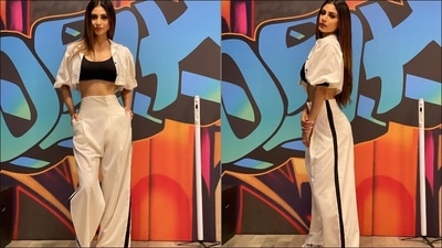 Completing her attire with a pair of spotless white sneakers, Mouni accentuated the spunk look with poker straight tresses, a dab of brown lipstick and amplified the glam quotient with smokey-eye makeup. (Instagram/imouniroy)