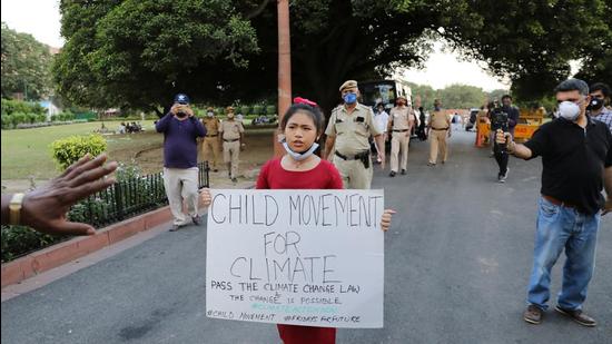 Licypriya Kangujam, 8, India's young climate activist, carrying a placard attends a protest demanding the passing of a climate change law outside the parliament in New Delhi, India, September 23, 2020. (REUTERS)