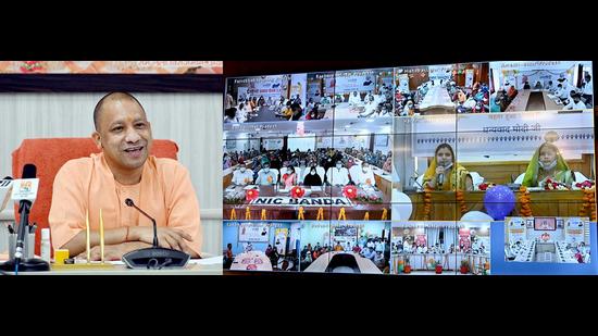 Uttar Pradesh CM Yogi Adityanath interacts with beneficiaries of Ujjwala 2,0 scheme, via video conferencing during a function at his official residence, in Lucknow on Wednesday. (ANI Photo)