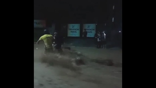 SDRF personnel rescue people in rain-hit Dehradun on Tuesday night.(Twitter/@uksdrf)