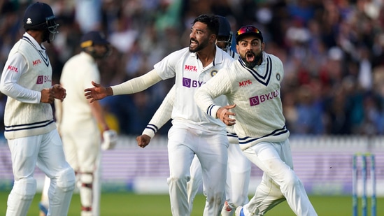 Bowler Mohammed Siraj and captain Virat Kohli of India celebrate