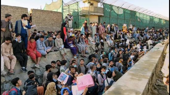 Crowds of people wait outside the airport in Kabul, Afghanistan, on Wednesday. (REUTERS)