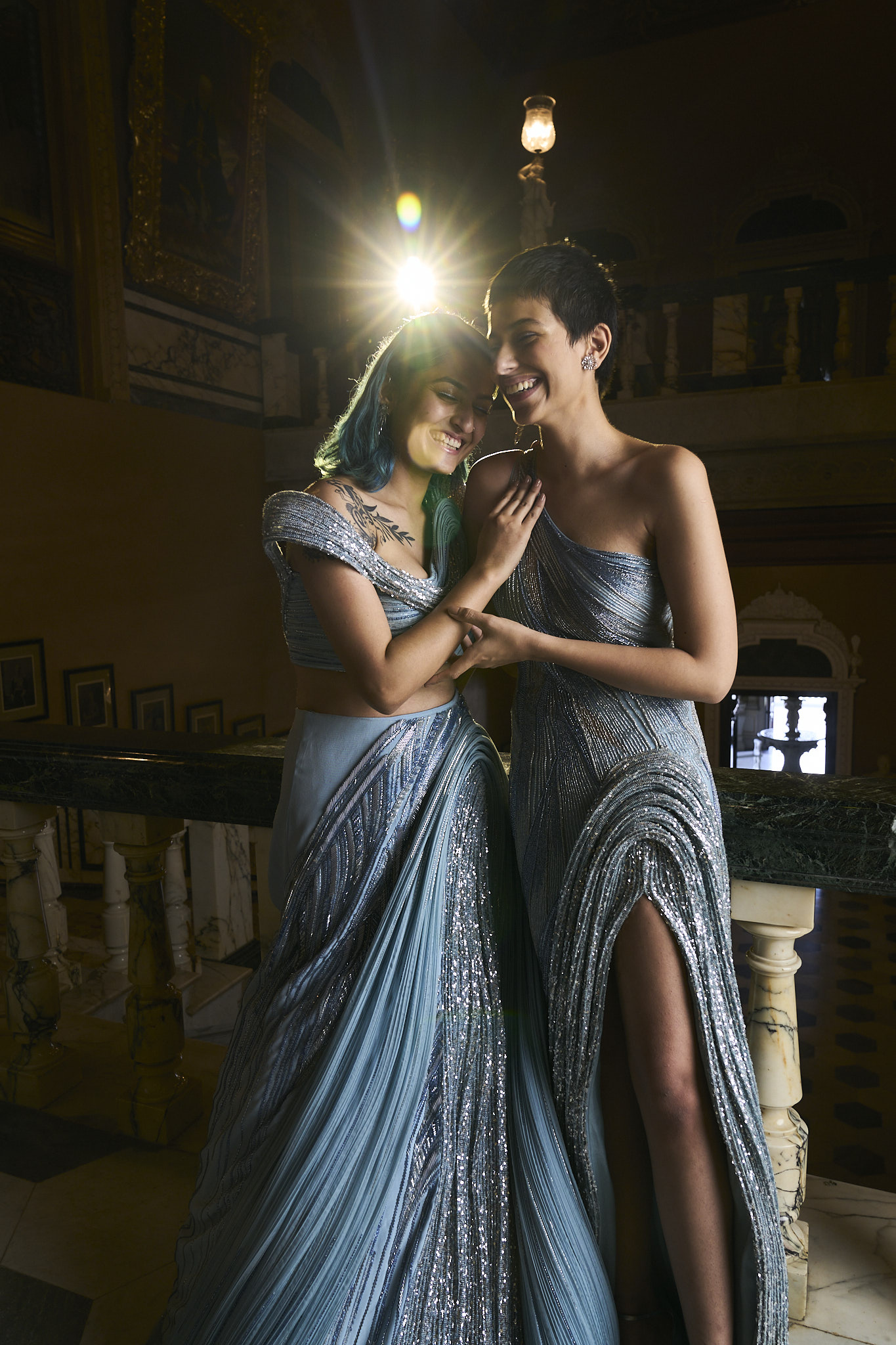 Showcasing a lesbian couple in galactic embroidered outfits in neptune blue