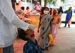 A health worker takes a swab sample from a youth to test for the Covid-19 coronavirus at a testing center in New Delhi. A health worker takes a swab sample from a youth to test for the Covid-19 coronavirus at a testing center in New Delhi.