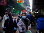 People wearing face masks walk on a street market, following an outbreak of the coronavirus disease (Covid-19) in Wuhan, Hubei province, China February 8, 2021. People wearing face masks walk on a street market, following an outbreak of the coronavirus disease (Covid-19) in Wuhan, Hubei province, China February 8, 2021.
