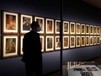 A women takes a photo of the artwork 'Demons of the Hour' by artist Werner Peiner at the exhibition 'Divinely Gifted List' at the German Historic Museum in Berlin, Germany. The exhibition at the German Historical Museum traces the lives and creations of several artists who made it onto the so-called 'Divinely Gifted List' from 1944, which was compiled on behalf of Adolf Hitler and other top Nazis.(AP Photo/Markus Schreiber) A women takes a photo of the artwork 'Demons of the Hour' by artist Werner Peiner at the exhibition 'Divinely Gifted List' at the German Historic Museum in Berlin, Germany. The exhibition at the German Historical Museum traces the lives and creations of several artists who made it onto the so-called 'Divinely Gifted List' from 1944, which was compiled on behalf of Adolf Hitler and other top Nazis.(AP Photo/Markus Schreiber)