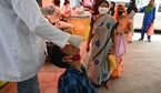 A health worker takes a swab sample from a youth to test for the Covid-19 coronavirus at a testing center in New Delhi. ( AFP)
