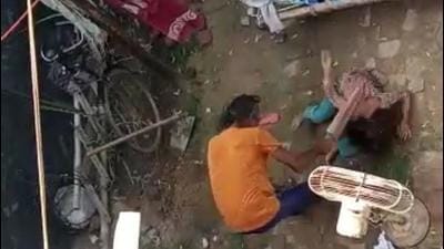 The man thrashing his daughter with a bat as shown in the video grab below. (HT PHOTO)