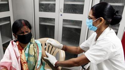 A beneficiary reacts while receiving a dose of the Covid-19 vaccine at Motilal Nehru Medical College, in Prayagraj on Wednesday, August 25. (ANI)