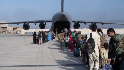 This handout photo courtesy of the US Air Force shows loadmasters and pilots assigned to the 816th Expeditionary Airlift Squadron, load passengers aboard a US Air Force C-17 Globemaster III in support of the Afghanistan evacuation at Hamid Karzai International Airport (HKIA) in Afghanistan on August 24, 2021. (AFP)