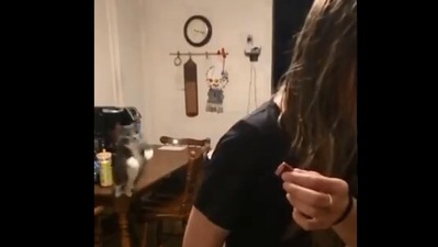 The image shows the cat leaping off the table. (Twitter/@MackBeckyComedy)
