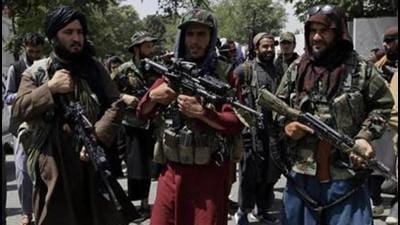 Taliban fighters patrol as two Traffic policemen stand, left, in Kabul, Afghanistan, Thursday, Aug. 19, 2021. The Taliban celebrated Afghanistan's Independence Day on Thursday by declaring they beat the United States, but challenges to their rule ranging from running a country severely short on cash and bureaucrats to potentially facing an armed opposition began to emerge. (AP Photo/Rahmat Gul) (AP)