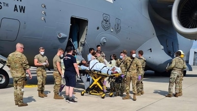 Medical support personnel from the 86th Medical Group help an Afghan mother and family off a U.S. Air Force C-17, call sign Reach 828, moments after she delivered a child aboard the aircraft upon landing at Ramstein Air Base, Germany, Aug. 21, 2021. (US Air Force photo)