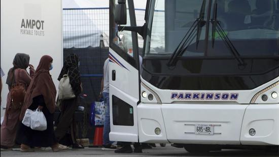 Refugees from Afghanistan and Canadian citizens board a bus after being processed at Pearson Airport in Toronto, Canada. (AP)