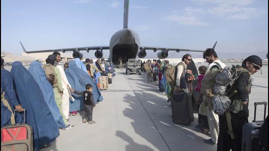 US Air Force loadmasters and pilots assigned to the 816th Expeditionary Airlift Squadron load people being evacuated from Afghanistan onto a US Air Force C-17 Globemaster III at Hamid Karzai International Airport in Kabul, Afghanistan. (AP)