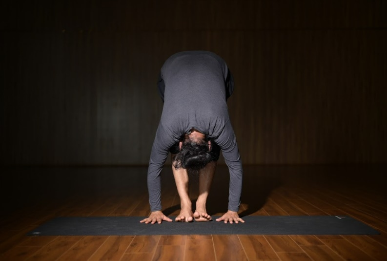 Padahasthasana (a variant of Uttanasana or Standing Forward Bend)&nbsp;(Grand Master Akshar)