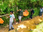 Conservationists carry the carcasses of three Sumatran tigers found dead in Ie Buboh village in South Aceh, Indonesia, Thursday. Conservationists carry the carcasses of three Sumatran tigers found dead in Ie Buboh village in South Aceh, Indonesia, Thursday.