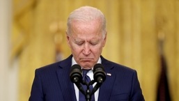 US president Joe Biden reacts during a moment of silence for the dead as he delivers remarks about Afghanistan from the East Room of the White House in Washington, on August 26, 2021. 