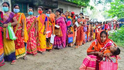 Beneficiaries wait in a queue to receive Covid-19 vaccine dose, at a government hospital in Nadia on Friday. (PTI) Beneficiaries wait in a queue to receive Covid-19 vaccine dose, at a government hospital in Nadia on Friday. (PTI)