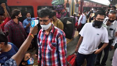 A BMC health worker checks temperatures before Covid-19 test of commuters arriving on outstation trains at Dadar station, in Mumbai on Thursday, August 26. (Satish Bate/HT photo)