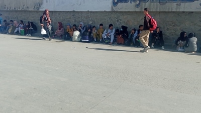 People walk a street near the Baron Hotel around Abbey Gate of Kabul's airport a day after the blasts. (via REUTERS)