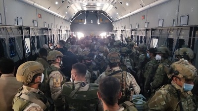 Spain has officially ended its operations in Afghanistan after its last two flights arrived in Dubai on Friday morning. In picture - Afghan collaborators, their families, Spanish soldiers and members of the embassy board a Spanish military plane at the Hamid Karzai International Airport in Kabul, Afghanistan. (Reuters)