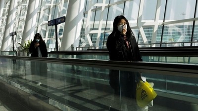 Travellers use their mobile phones at Wuhan Tianhe International Airport following the coronavirus disease (Covid-19) outbreak in Wuhan, Hubei province. (REUTERS)