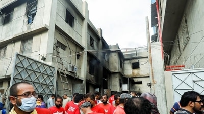 Rescue workers are seen, after a fire broke out at a multi-story chemical factory, in Karachi, Pakistan. (REUTERS)