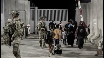 US Army soldiers with the 82nd Airborne Division direct evacuees towards buses at Hamid Karzai International Airport, Kabul, Afghanistan. (REUTERS) US Army soldiers with the 82nd Airborne Division direct evacuees towards buses at Hamid Karzai International Airport, Kabul, Afghanistan. (REUTERS)