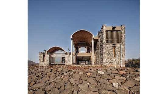 Shah House, built near Pune, stands at the edge of a river on agricultural land, the complex is shared by two residences. Locally available basalt stone is the primary building material and is combined with handmade terracotta hollow tubes for vaulted roofs as with Wall House. The design offers a continuous view of the waterfront through the selected axes of the house.(Picture courtesy Javier Callejas)