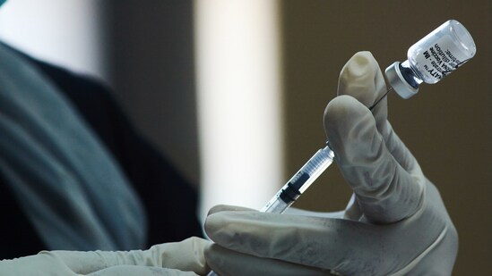 A health worker prepares a dose of the Pfizer-BioNTech Covid-19 vaccine.(Bloomberg file photo)
