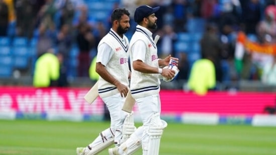 India's captain Virat Kohli, right, and batting partner Cheteshwar Pujara walk off the field at the end of play on the third day of third Test(AP)