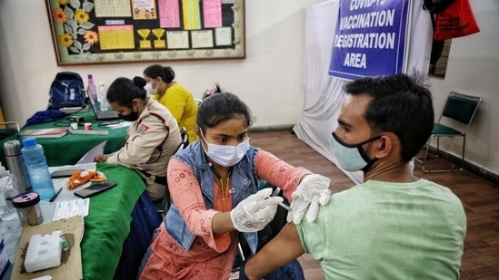 A health worker administers a Covid-19 vaccine shot to a man at an inoculation centre on DDU Marg in New Delhi.(Sanchit Khanna/ Hindustan Times)
