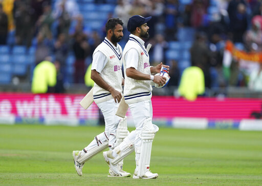 India's captain Virat Kohli, right, and batting partner Cheteshwar Pujara walk off the field at the end of play on the third day of third Test India's captain Virat Kohli, right, and batting partner Cheteshwar Pujara walk off the field at the end of play on the third day of third Test