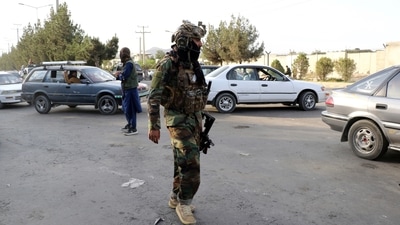 Taliban fighters stand guard near the gate of Hamid Karzai international Airport in Kabul, Afghanistan. (AP) Taliban fighters stand guard near the gate of Hamid Karzai international Airport in Kabul, Afghanistan. (AP)