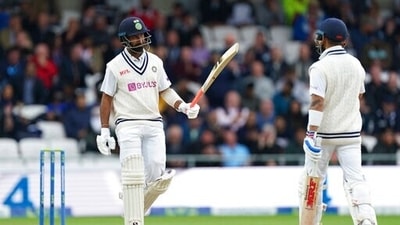 India's Cheteshwar Pujara, left, raises his bat to celebrate scoring fifty runs. (AP) India's Cheteshwar Pujara, left, raises his bat to celebrate scoring fifty runs. (AP)