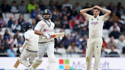 England's Craig Overton, right, reacts as India's captain Virat Kohli, center, and Cheteshwar Pujara, left, run between the wickets. (AP) England's Craig Overton, right, reacts as India's captain Virat Kohli, center, and Cheteshwar Pujara, left, run between the wickets. (AP)