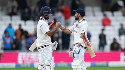 India's captain Virat Kohli, right, and batting partner Cheteshwar Pujara celebrate. (AP) India's captain Virat Kohli, right, and batting partner Cheteshwar Pujara celebrate. (AP)
