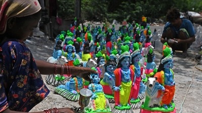 Artisans give finishing touches to the idols of Lord Krishna ahead of the 'Janmashtami' at a workshop in Chennai. (AFP)