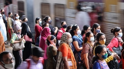 Commuters wearing protective face masks wait to board a suburban train after authorities resumed train services for vaccinated passengers amid the coronavirus disease (Covid-19) pandemic, in Mumbai. (File Photo / REUTERS)