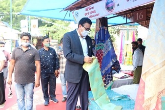Additional Chief Secretary Information and MSME (UP), Navneet Sehgal, at one of the artisans' stall at Dilli Haat on Saturday.