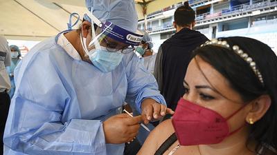 A woman receives the second dose of the Moderna Covid-19 vaccine at the National Stadium in Tegucigalpa, Honduras on Friday. (AFP) A woman receives the second dose of the Moderna Covid-19 vaccine at the National Stadium in Tegucigalpa, Honduras on Friday. (AFP)