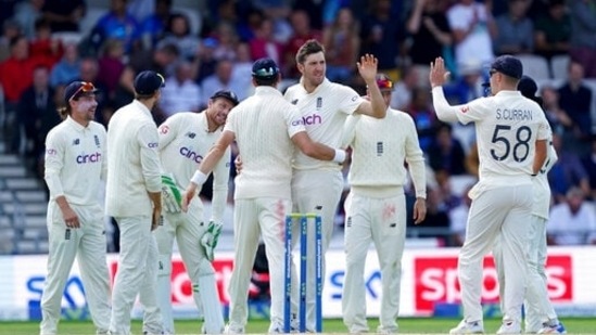 England's Craig Overton, center without cap, celebrates with teammates the dismissal of India's Ravindra Jadeja during the fourth day of third test cricket match between England and India, at Headingley cricket ground in Leeds, England, Saturday, Aug. 28, 2021. (AP Photo/Jon Super)(AP)